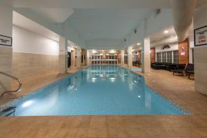 a large swimming pool in a building at Holiday Inn Corby Kettering Hotel & Spa in Corby