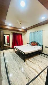 a bedroom with a large bed in a room with a rug at Arbuda inn in Mount Ābu