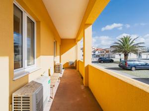 a balcony with benches and a window in a building at Casa Mar in Cortegaça