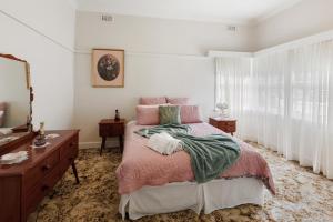 a bedroom with a bed and a dresser and a mirror at Nan's House in Mansfield