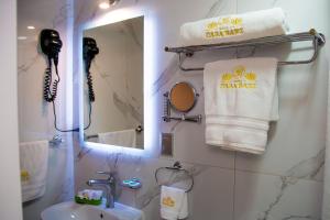 a bathroom with a sink and a mirror and towels at HOTEL CASA BAEZ in Pátzcuaro +116 photos