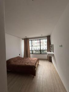 a bedroom with a bed and a large window at Ijou gdena in Sidi Daoud +19 photos