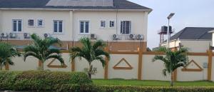 a white house with palm trees in front of it at Dvyne Lux Home - Lagos in Ikeja