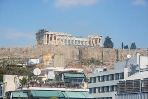 a building on top of a hill with a castle at Art Gallery Hotel Athens in Athens