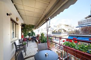 a balcony with a table and chairs on a balcony at Art Gallery Hotel Athens in Athens
