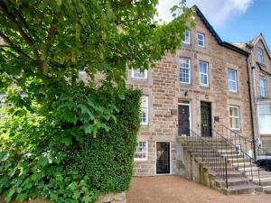 an ivy covered building with stairs in front of it at 2 Bed in Harrogate oc-hh029 in Harrogate