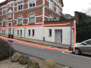 a building with a red line on the side of a street at Stor lejlighed ved togstation in Viborg
