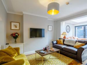 a living room with a couch and a tv at 4 Bed in Harrogate oc-hh025 in Harrogate