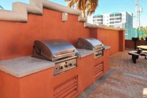 an outdoor kitchen with two burners on a patio at Destin Towers 32 in Destin