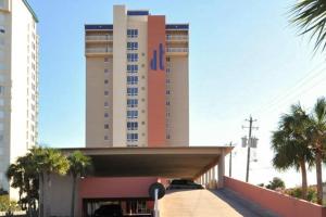 a hotel building with a parking garage in front of it at Destin Towers 32 in Destin