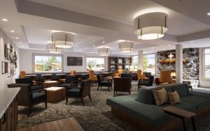 a lobby with a waiting room with couches and chairs at Gray Wolf Inn & Suites in West Yellowstone