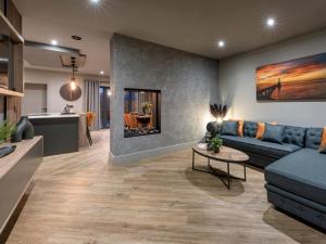 a living room with a blue couch and a table at 4 Bed in Morpeth oc-93775 in Thropton