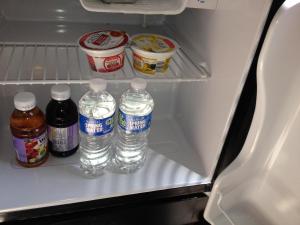 a refrigerator with bottles of water and other food at Main Street Bed & Breakfast in Hannibal