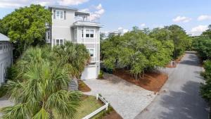 an aerial view of a white house with trees at 80 Blue Sky in Santa Rosa Beach +58 photos