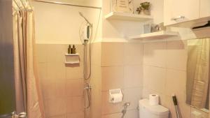 a small bathroom with a shower and a toilet at Corner Studio w Wi-Fi CasaMira Labangon in Cebu City