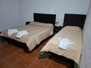 a room with two beds with towels on them at San Antonio Casa Quinta in Banda Florida +11 photos