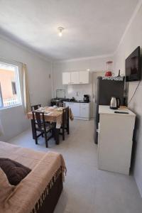 a kitchen and dining room with a table and a refrigerator at Apartlaguna Prime in Laguna