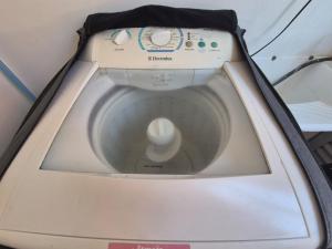 a white washing machine with a white object in it at Apartlaguna Prime in Laguna