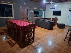 a dining room with a table and chairs and a couch at San Antonio Casa Quinta in Banda Florida