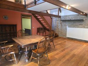 a dining room with a wooden table and chairs at Apartment in a Chateau with Park in Trébry