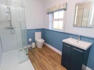 a bathroom with a toilet and a sink and a shower at Linn Cottage in Hexham +32 photos