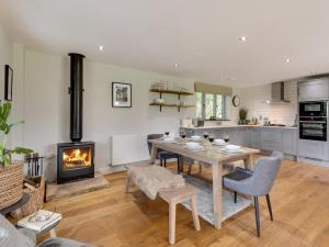a kitchen with a dining table and a fireplace at 3 Bed in Otley oc-g0176 in Timble