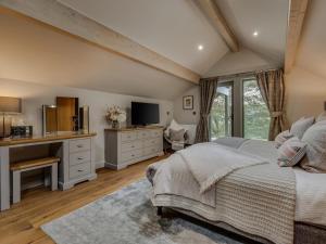 a bedroom with a bed and a desk and a television at 3 Bed in Otley oc-g0176 in Timble