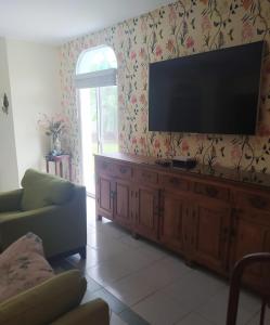 a living room with a flat screen tv on the wall at Privat 3 bedroom apartment in Sosua