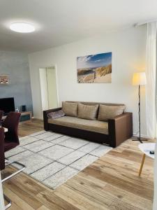 a living room with a couch and a table at Modern 2-Room Apartment with Free Parking and Balcony in Waldmohr