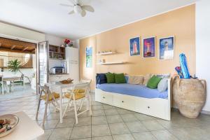 a bedroom with a bed and a table and a dining room at Gelso Selvatico by BarbarHouse in Specchiolla +19 photos