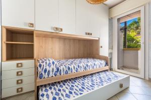 a bedroom with a bed and cabinets and a window at Gelso Selvatico by BarbarHouse in Specchiolla