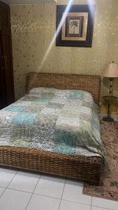 a bed with a blanket on it in a room at Privat 3 bedroom apartment in Sosua +5 photos