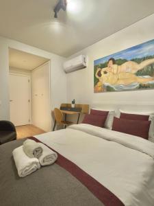 a bedroom with a large bed with a towel on it at Suíte aconchegante in Lisbon