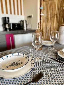 a table with plates and wine glasses on it at Clewis in Saint Malo