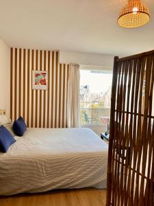 a bedroom with a bed and a window at Clewis in Saint Malo +16 photos