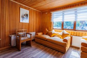 a living room with a couch and a window at Hostal Royal Austral in Coihaique