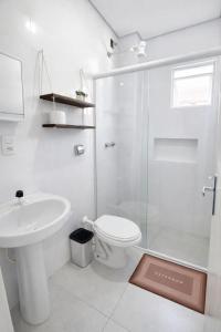 a bathroom with a toilet sink and a shower at Apartlaguna Prime in Laguna +10 photos