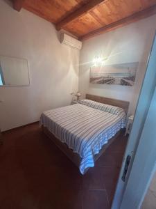 a small bedroom with a bed in a room at Residenza il Normanno - La terrazza sul mare in Santa Domenica +63 photos