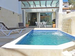 a swimming pool in a yard with a chair and a patio at VILLA MON REPOS CON PISCINA Y A/A in Colera