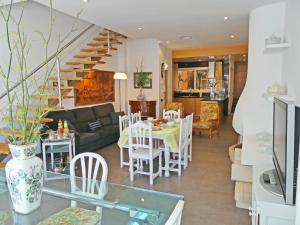 a living room and dining room with a table and chairs at VILLA MON REPOS CON PISCINA Y A/A in Colera