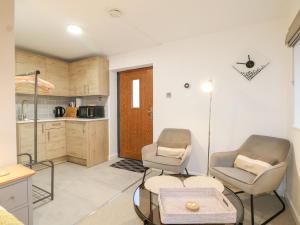 a living room with two chairs and a table at The BullpenManor Farm in Salisbury