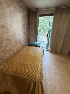 a bedroom with a bed and a large window at Cantinho do Imperador in Petrópolis +56 photos