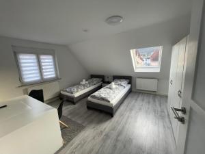 a living room with two beds and a table at 5-Täler Stern in Geislingen an der Steige