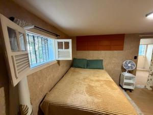 a bedroom with a bed in a room with a window at Cantinho do Imperador in Petrópolis