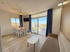 a living room with a couch and a table at Agi Rescator Apartments in Roses
