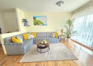 a living room with a couch and a table at Komfortferienwohnung Kreideblick in Sassnitz