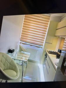a kitchen with a table and a chair and a window at Lux studio 46 meters in Colentina +3 photos