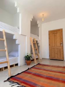 a room with two bunk beds and a door at Hakuna Matata Guest House in Tamraght Ouzdar