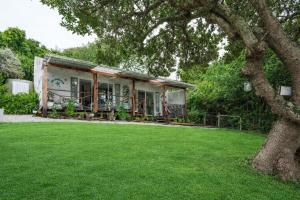 a house with a green lawn in front of it at 302 On Old Sea View Road Chelsea in Port Elizabeth