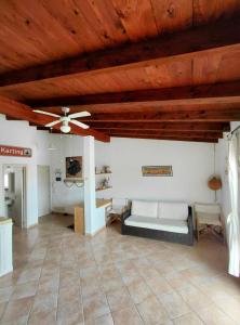 a living room with a ceiling fan and a couch at Attico Surfhouse Mistral Estoril in Sal Rei